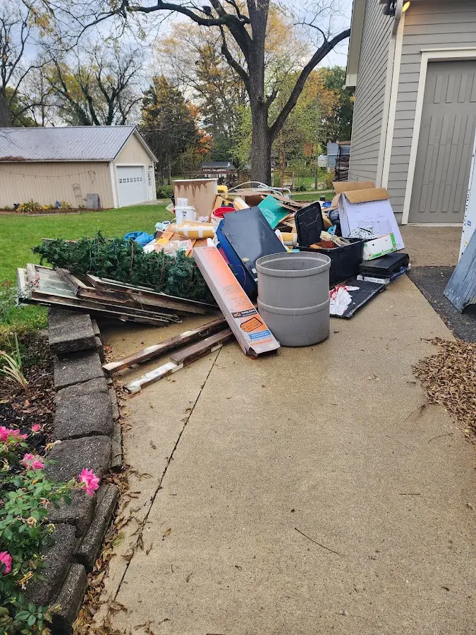 Dumpster being loaded with debris for Commercial Dumpster Rental in Ardmore